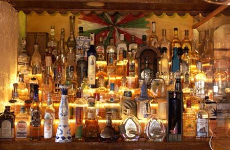 Image of bar with bottles of alcohol backlit